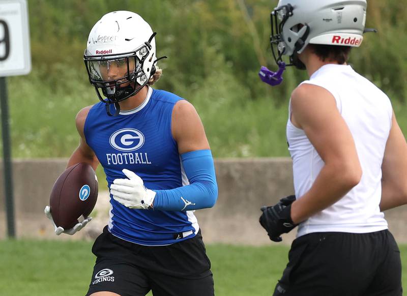 Geneva’s Finn Weppner carries the ball after a catch Tuesday, July 16, 2024, during their matchup with Kaneland in the Kaneland 7-on-7 at the school in Maple Park.