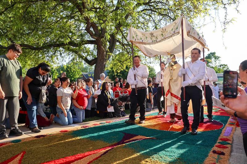 The Rev. Matthew Pratscher, pastor of St. John Paul II, carries the Eucharist in the monstrance as the National Eucharistic Pilgrimage arrived to St. John Paul II parish grounds on Sunday, May 18, 2025.