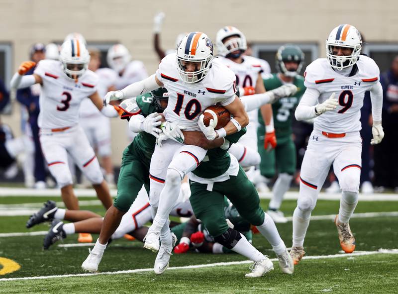 Oswego's Mariano Velasco (10) runs the ball during the varsity football second-round 8A playoff game between Oswego and Lane Tech on Saturday, Nov. 8, 2025 in Chicago.