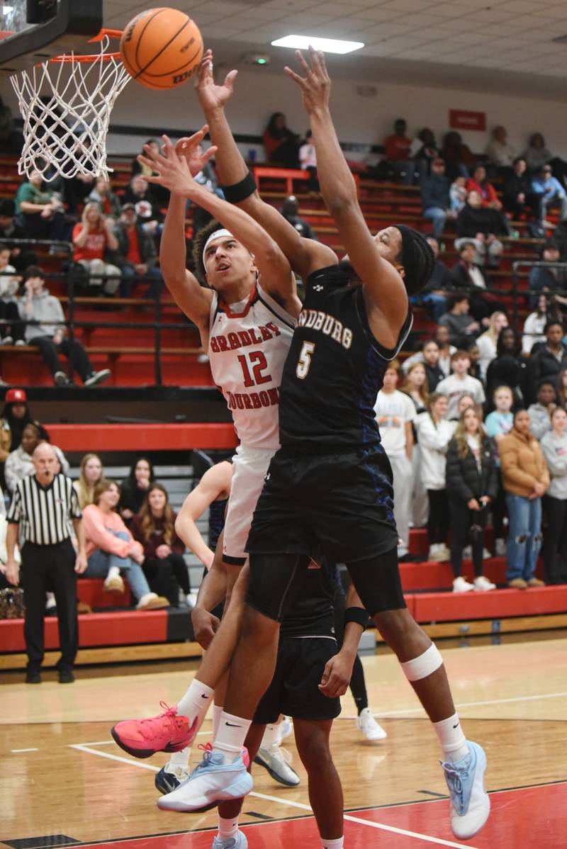 Bradley-Bourbonnais' Jakobi Pierce, left, and Sandburg's Jonah Johnson battle for a rebound during a game at Bradley-Bourbonnais Tuesday, Feb. 3, 2026.