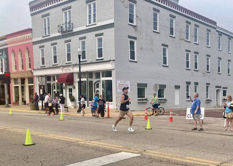 Brent Loftus, 26, of Princeton finishes the Princeton Mile Race Saturday morning.