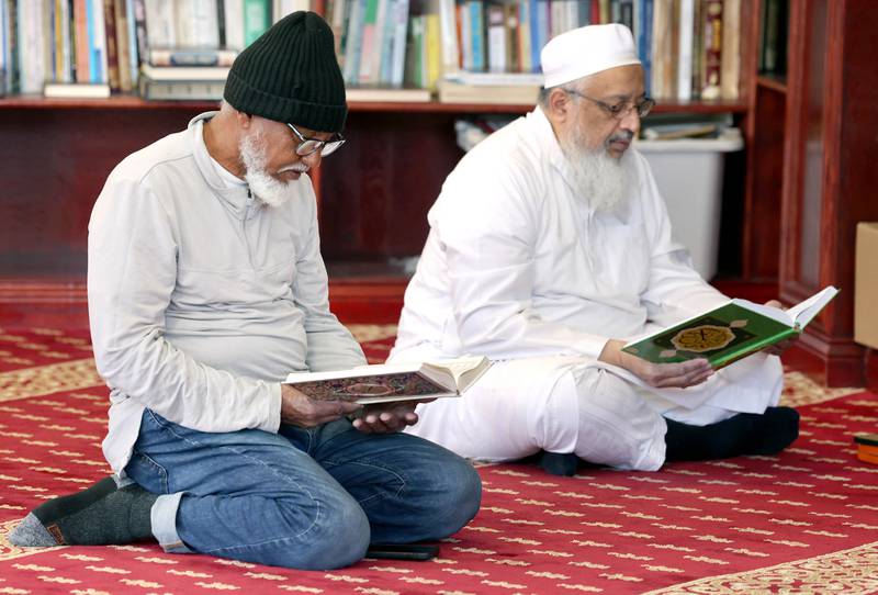 Two men read the Quran Friday, April 7, 2023, in the prayer hall, or musallā, at the Islamic Center of DeKalb. Muslims are currently observing the holy month of Ramadan.