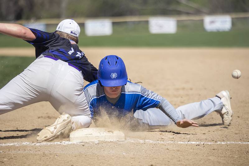 The ball gets away from Dixon’s Brady Lawrence as Newman’s Daniel Kelly dives back to first on a pick off attempt Saturday, April 13, 2024 at Veterans Memorial Park in Dixon.