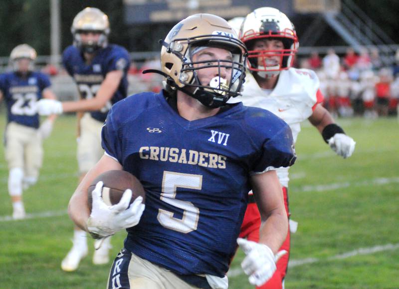 Marquette's Tommy Durdan (5) runs in the first touchdown of the game against Dee-Mack at Gould Stadium on Friday, Sept. 9, 2022.