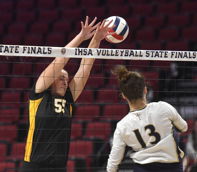 Riverdale's Katie Cox tries to block a spike by Central Catholic's Addison Hoeniges in the Rams's 2A semifinal match at the state volleyball tournament at Illinois State University on Friday, Nov. 14, 2025.