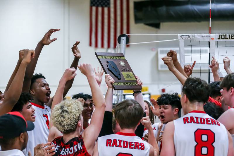 Bolingbrook celebrates with the Joliet West Regional Championship plaque after defeating Joliet West.  May 23, 2024.