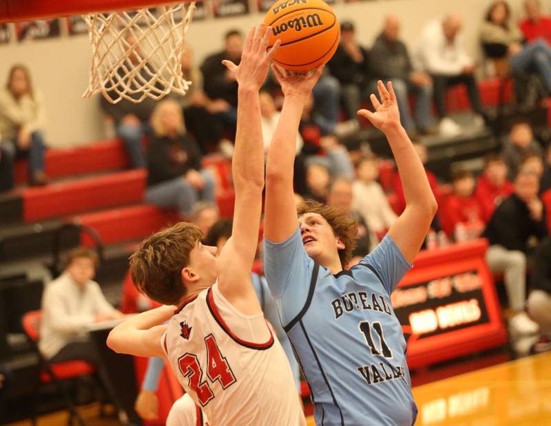 Bureau Valley's Blake Foster posts up a shot over Hall's Gage Olson on Wednesday, Jan. 28, 2026 at Hall High School.