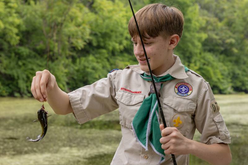 Nathan Fessler assesses the bluegill that he caught during the 38th Annual Kid's Free Fishing Tournament on June 7, 2025 at Lock 14 in La Salle.