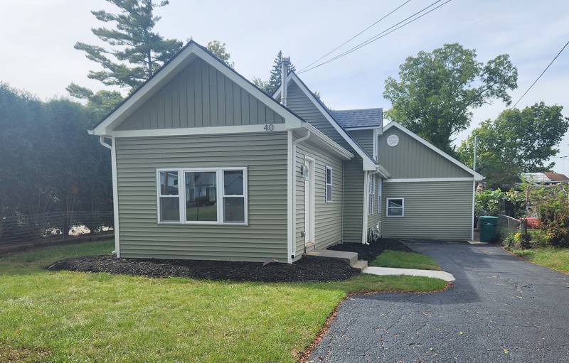 Tara Farnsworth and Bob Albrecht of Antioch, HomeVestors of America, Inc., franchisees, flipped this home on Lippincott Road in Fox Lake, winning them the 2024 Ugliest House Of The Year award from the company.