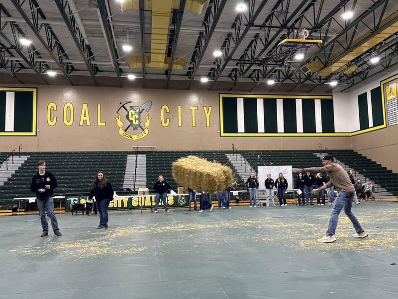 A member of the staff tosses a hay bail as far as he can during the FFA Week kickoff on Monday, Feb. 23, 2026.