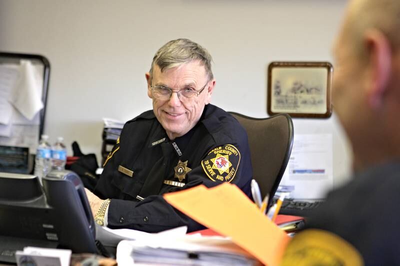 DeKalb County Sheriff Roger Scott is seen in his office in Sycamore, Ill., during a meeting on Tuesday, Jan. 28, 2014. Scott, who began in the communications division and has been elected sheriff seven times, was recognized for 45 years of service at a recent county board meeting.