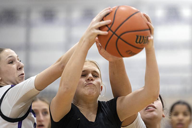 Sycamore’s Quinn Carrier pulls in a rebound Monday, Dec. 4, 2023 in Dixon.
