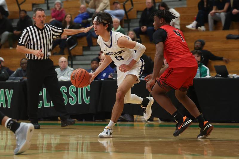 St. Francis’ Dylan Ston looks for a play against Bolingbrook in the Jack Tosh 2023 Holiday Classic on Wednesday, Dec.27th, 2023 in York.