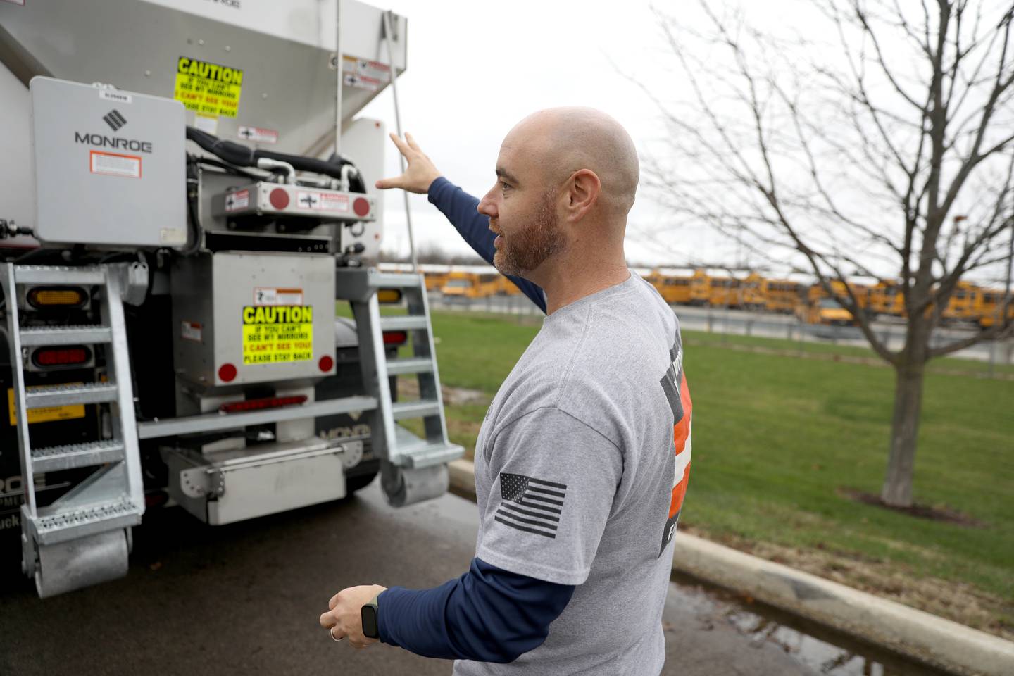 Oswego Assistant Director of Public Works Operations Brian Evans shows some of the features on a new truck the department recently acquired that has many uses in all seasons, including plowing snow and laying down salt.