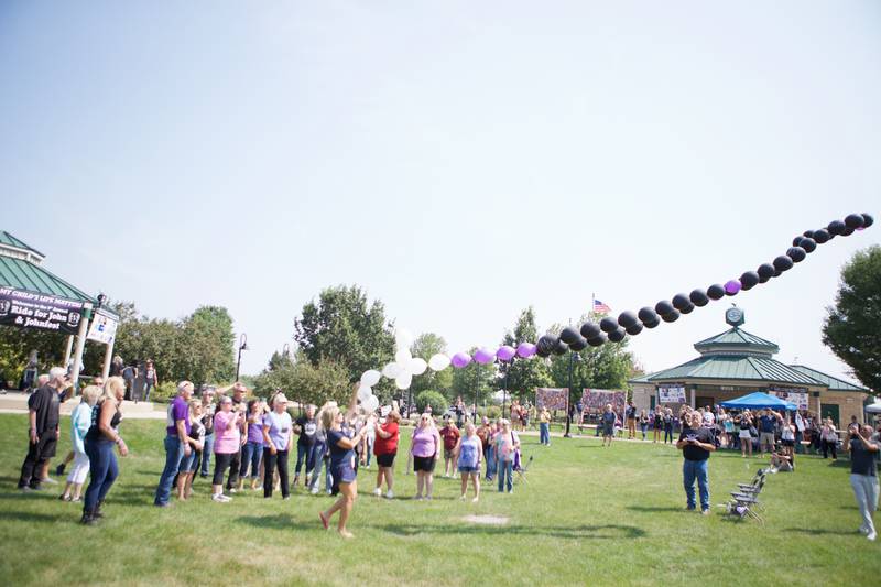 Families who have lost loved ones to fentanyl poisoning  release a ballon cross necklace that has messages to their lost loved ones at the  9th Annual Ride for John and JohnFest for my child's life matters on Saturday Aug.2, 2025 in Carol Stream.