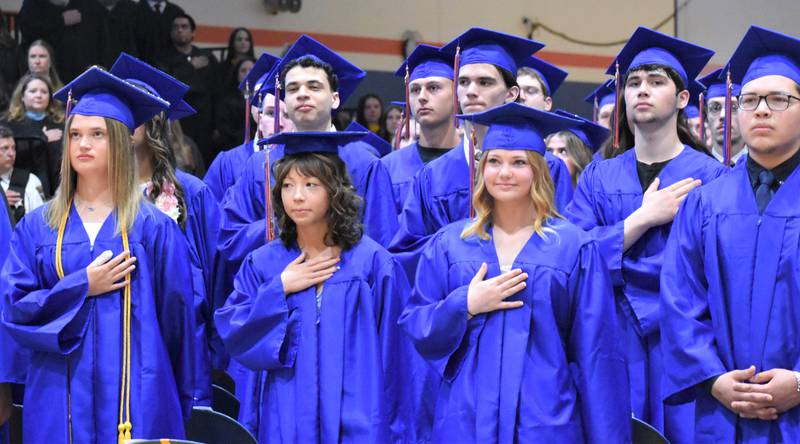 Genoa-Kingston graduates stand at their seats Sunday, May 17, 2026, during the commencment ceremony at Genoa-Kingston High School.