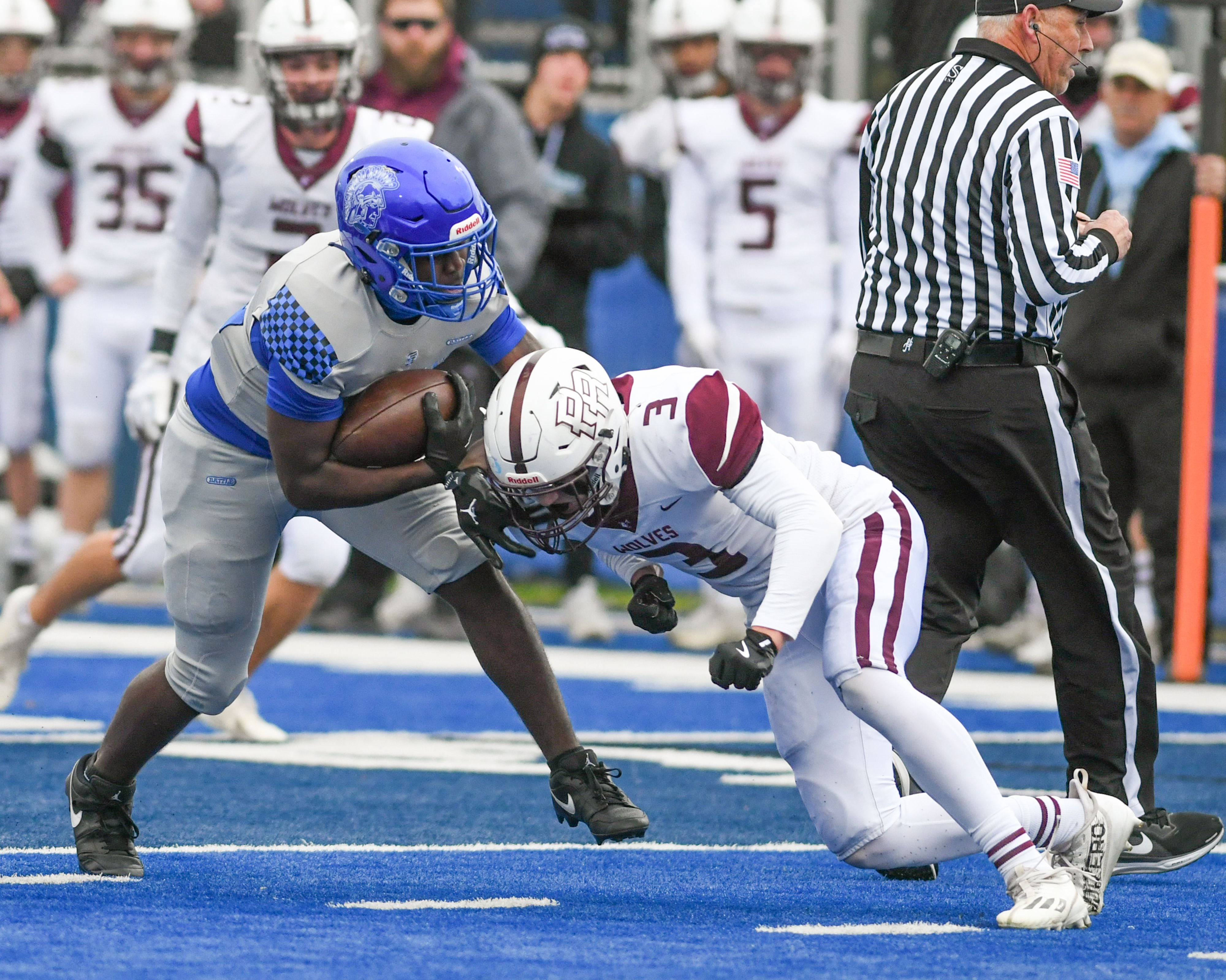 St. Francis's Tivias Caldwell jr. (42) gains some yards before being brought down by Prairie Ridge's Eligah Loeding (3) during the second round of the 5A playoff game on Saturday Nov. 8, 2025, held at St. Francis's High School.
