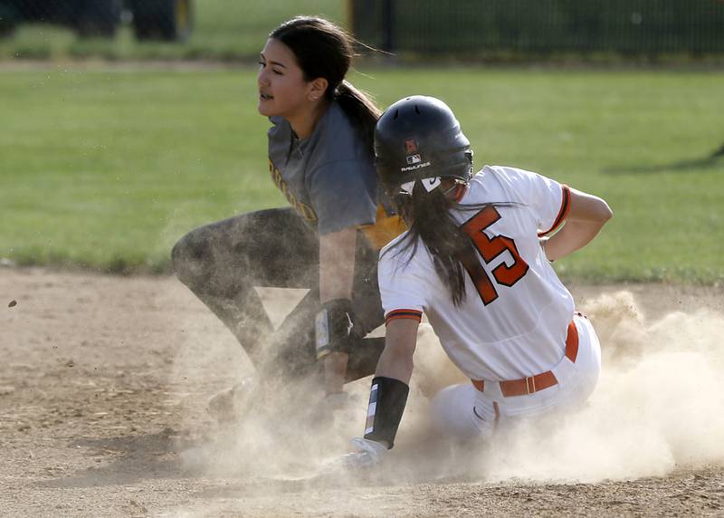 Crystal Lake Central’s Carone Gianna slides into second base after the throw got past Harvard’s Ytzel Lopez during a nonconference softball game Monday, May 15, 2023, at Crystal Lake Central High School.