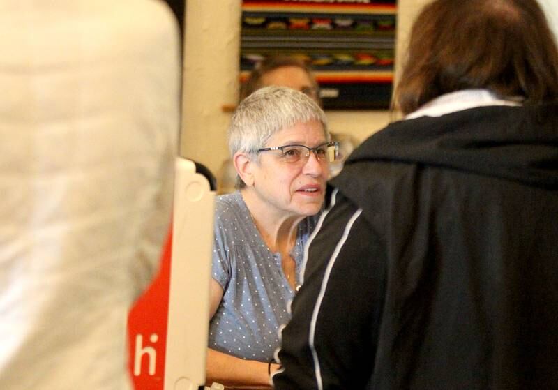 Election Judge Patty Gabris helps a voter at the First Methodist Church polling place in Downers Grove for the General Election on Tuesday, Nov. 8, 2022.