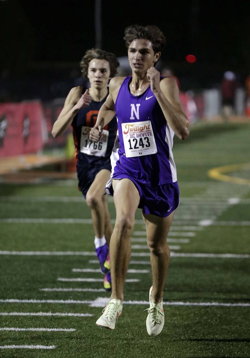 Caden Weber of Downers Grove North and Nick Parrell of Oak Park-River Forest) Wednesday October 5, 2022 at the Naperville North twilight cross country meet.