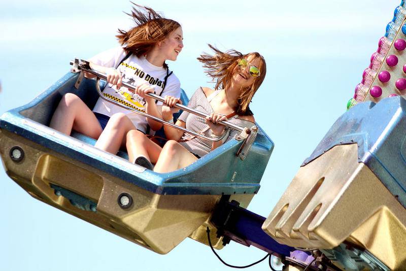 Cali Roberts, 15, (right) and Emily Dutton, 15, (left) both of Oswego, were all smiles on The Predator at the Windy City Amusements carnival on the grounds of PrairieFest on Friday afternoon. Having come to PrairieFest for many years, both agreed that their favorite part of the festival was "The rides and being able to hang out with friends."