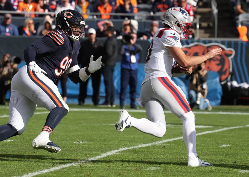 Chicago Bears defensive tackle Gervon Dexter Sr. pursues New England Patriots quarterback Drake Maye during their game Sunday, Nov. 10, 2024, at Soldier Field in Chicago.