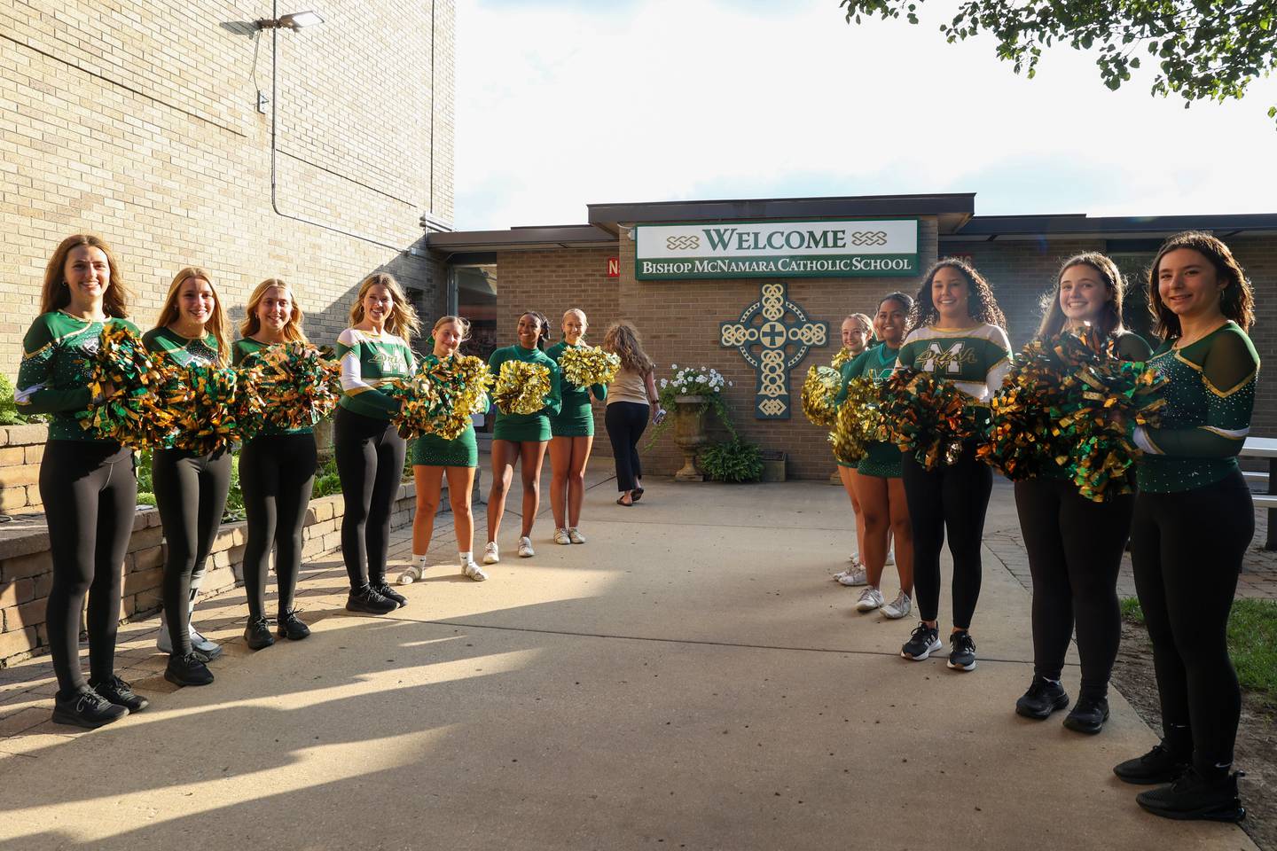 Cheerleaders welcome attendees to Bishop McNamara Catholic High School in Kankakee on Thursday, Aug. 21, 2025, for the ribbon-cutting ceremony of the new Rich Zinanni Athletic Complex.