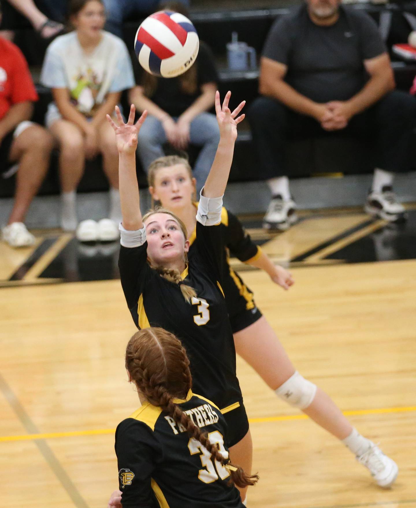 Putnam County's Megan Wasilewski sets the ball in the air between teammates Salina Breckenridge and Maggie Spratt on Thursday, Sept 7, 2023 at Putnam County High School.