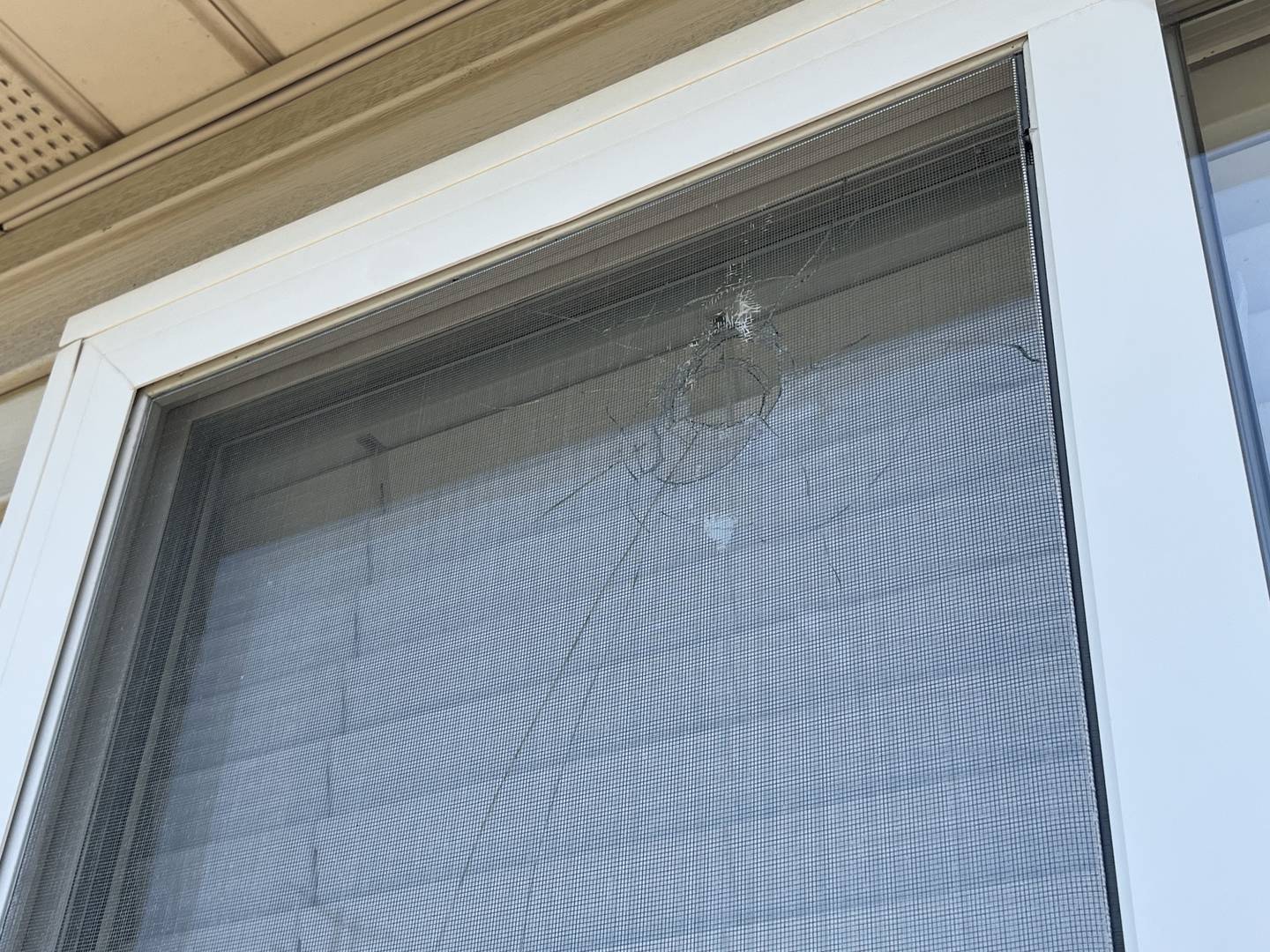 A window of a Romeoville residence damaged by a bullet, seen on Friday, May 26, 2023. A shooting occurred on Thursday, May 26, 2023, near the area as officers were trying to apprehend a suspect in a stolen motor vehicle incident.