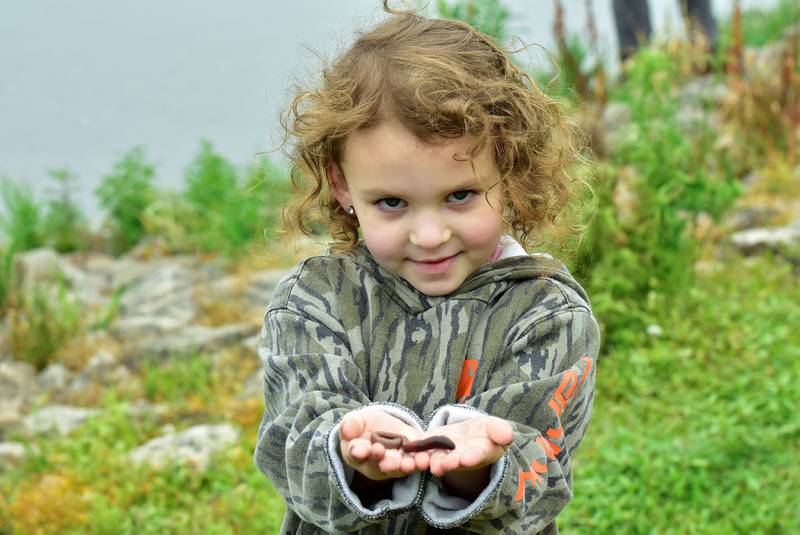 Josie Pageloff, 4, enjoyed playing with the worms more than she did feeding them to the fish on Saturday morning, June 14, 2025 during the 19th annual Dick Brown Fishing Derby held at Prophetstown State Park.
