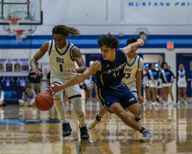 Leyden's Jack Tinajero (11) battles Downers Grove South's Keon Maggitt (1) for possession during basketball game between Leyden at Downers Grove South. Feb 9, 2024.