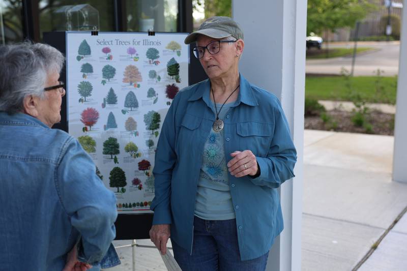 Rita Renwick, a member of the City of Joliet Tree Advisory Board, talks with a resident about the variety of trees in Will County at the Green Escape Earth Day Event on Wednesday, April 22, 2026 in Joliet.
