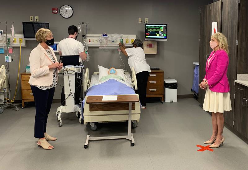 First lady Jill Biden, right, speaks to Christy Vincent, dean of health professions at Sauk Valley Community College, Monday during a tour of the facility.
