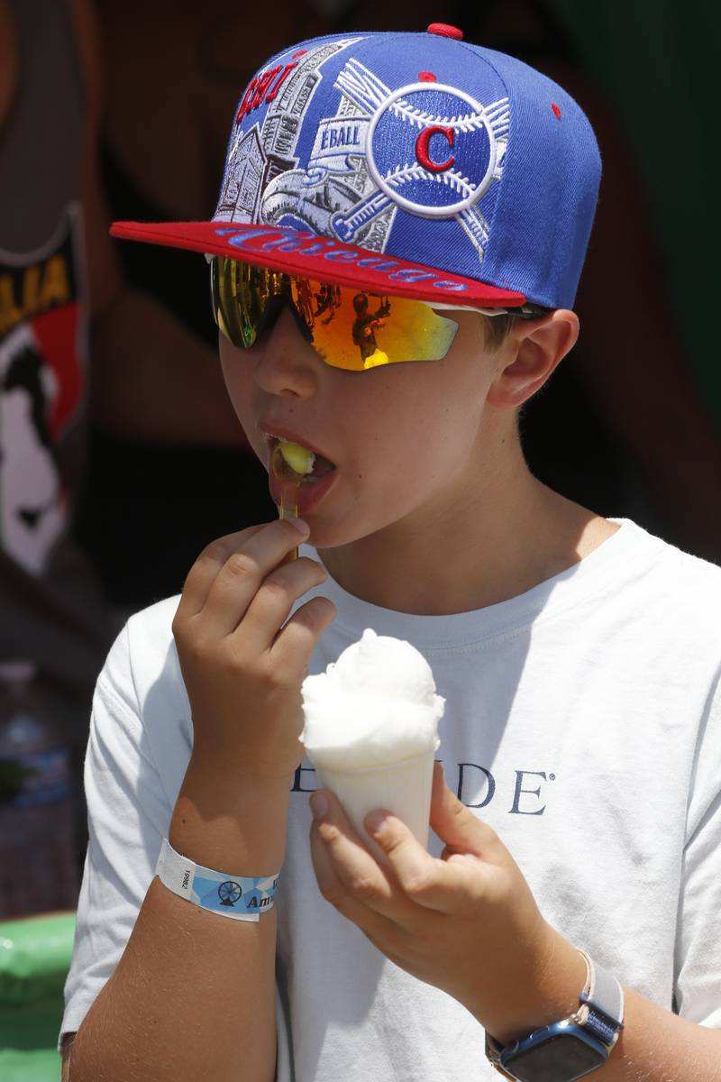 Brandon C. enjoys Italian ice during Lakeside Festival on Thursday, July 3, 2025, on the grounds of the historic Dole Mansion in Crystal Lake,