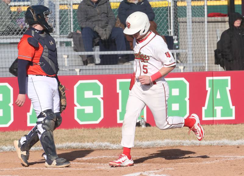 L-P's Brevyn Vogel crosses home plate to score the teams first run against Pontiac on Monday, March 24, 2025 at Huby Sarver Field inside the L-P Athletic Complex in La Salle.