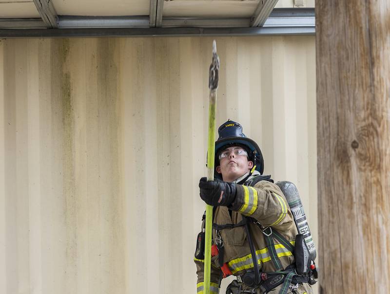 Cadet firefighter Kade Politsch learns the proper way to break through sheetrock Saturday, March 15, 2025, during training in Amboy.