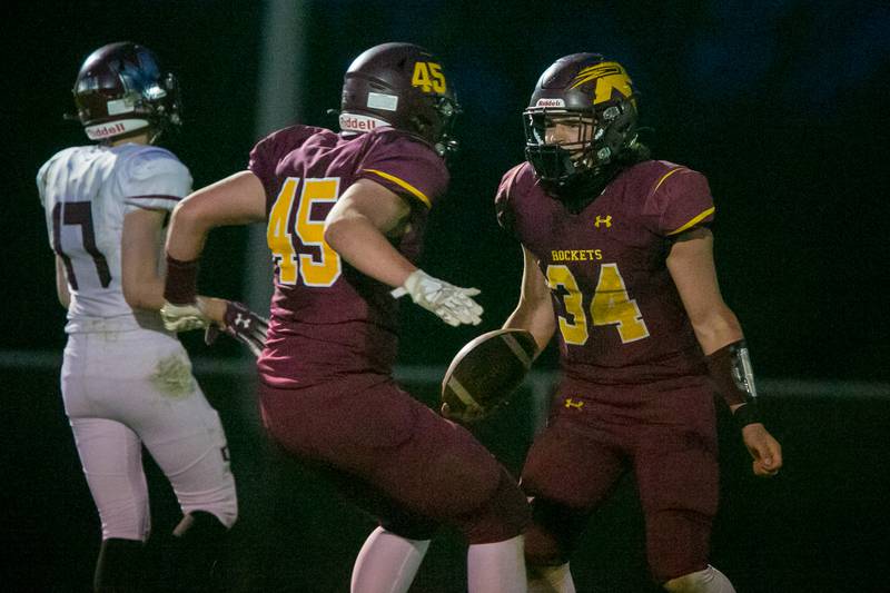 Richmond-Burton running back Brock Wood (34) celebrates a touchdown in the second quarter of the game at Richmond-Burton High School on Friday, April 23, 2021, in Richmond, Ill. The Rockets won, 50-7.