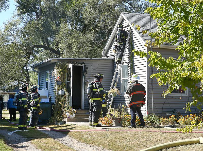 Ottawa, Naplate and Wallace firefighters work the scene of a house fire at 1529 Sycamore Street on Monday, Oct. 3, 2022 in Ottawa. The fire began shortly before 2p.m.