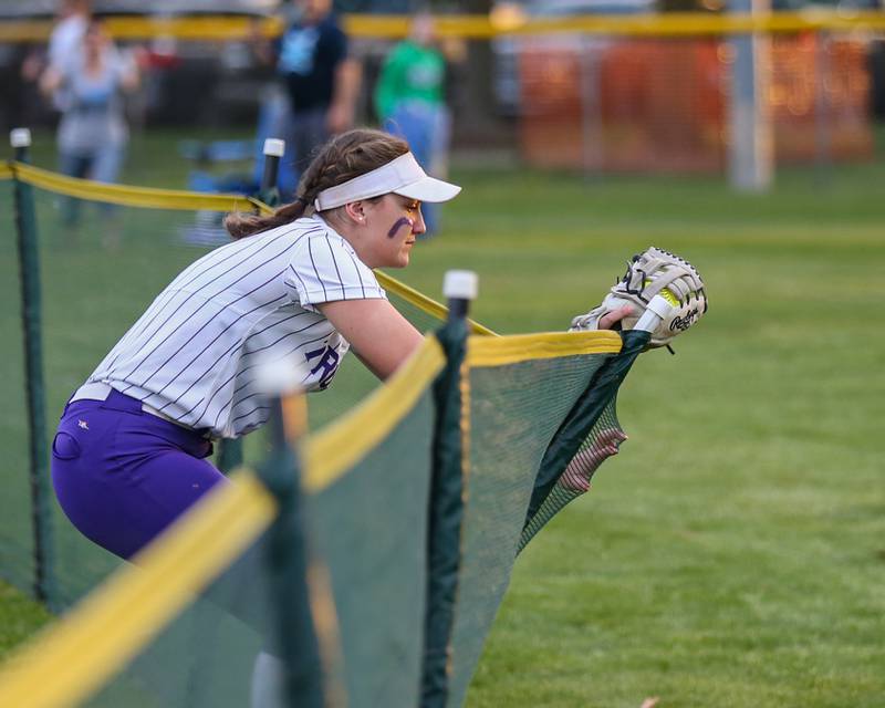 Downers Grove North's Cali Bailey (8) makes a catch at the fence during varsity softball game between Downers Grove South at Downers Grove North.  May 11, 2023.