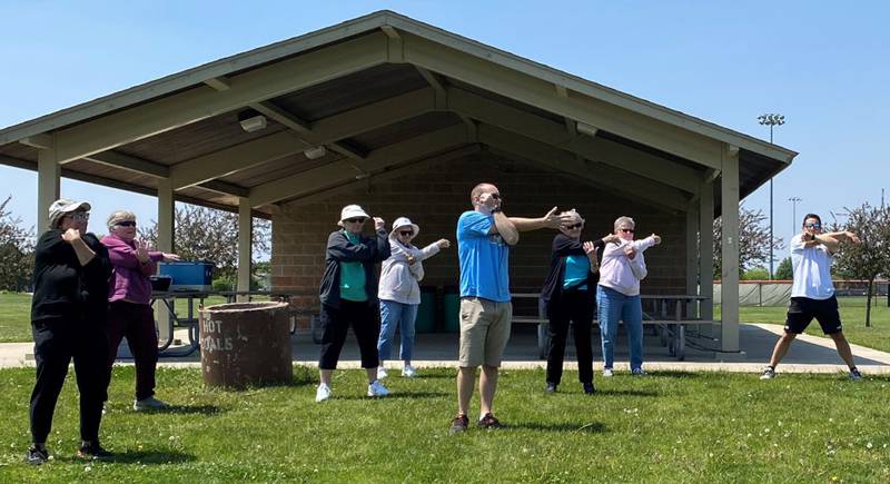 Participants stretch with Oswego Village President Ryan Kauffman during a previous Move with the Mayor event.