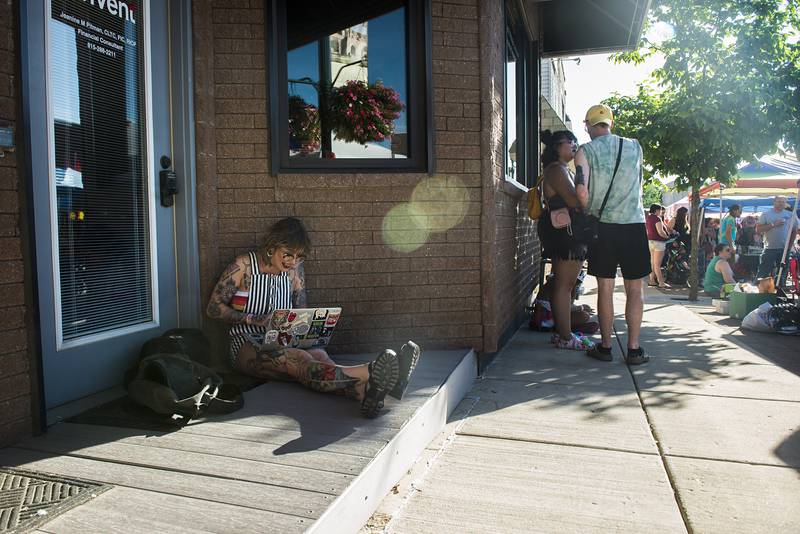 Photographer Tilly Seydel works on uploading photos Saturday, June 18, 2022 after taking some pictures at Dixon’s Pride Fest.