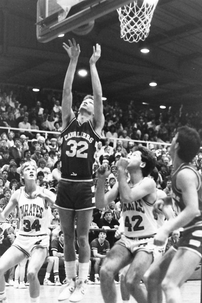 L-P's John Happ lets go of a shot under the hoop over Ottawa's Dave Yell and Rick Hayne during the Regional title game on Saturday, Feb. 28, 1986 at La Salle-Peru Township High School.