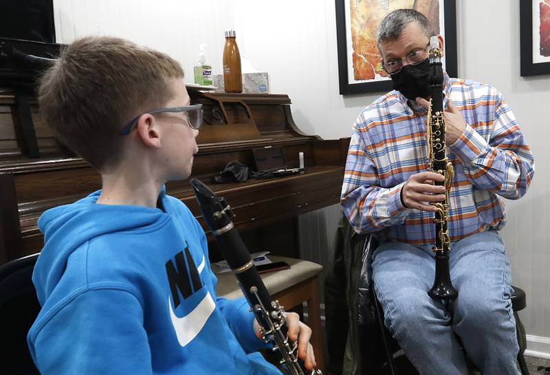 Music teacher Keith Hulen teaches Ethan White, 12, of Crystal Lake, during a clarinet lesson Tuesday, Feb. 22, 2022, at Encore Music Academy, 87 N. Williams St., in Crystal Lake. The academy moved into its new location over Thanksgiving week last year. The larger location allows for the expansion of its private student instruction and also has a large space suitable for performing.