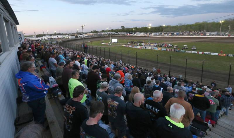 Thousands of spectators stand for the National Anthem during the season opening race on Tuesday, May 6, 2025 at La Salle Speedway.
