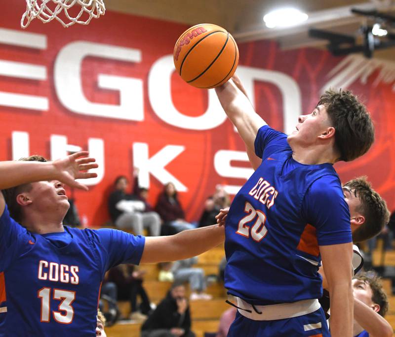 Genoa-Kingston's Jaiden Lee (20) and Conner Harney (13) rebound against Marengo on Monday, Nov. 24, 2025 during the Oregon Boys Basketball Thanksgiving Tournament in Oregon.