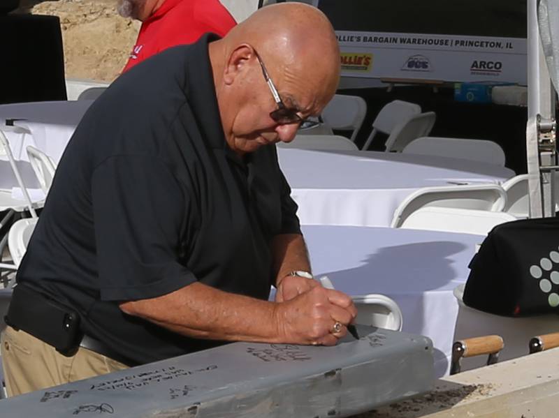 Former Princeton mayor Keith Cain signs a steel beam that will be hung in the new Ollie's distribution center on Tuesday, Sept. 26, 2023 in Princeton.