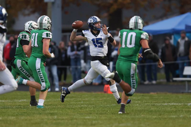 Clifton Central senior quarterback Brady Shule throws a pass under pressure from Dwight defenders during Dwight's 43-14 victory over Clifton Central in second round playoffs on Saturday, Nov. 8, 2025.