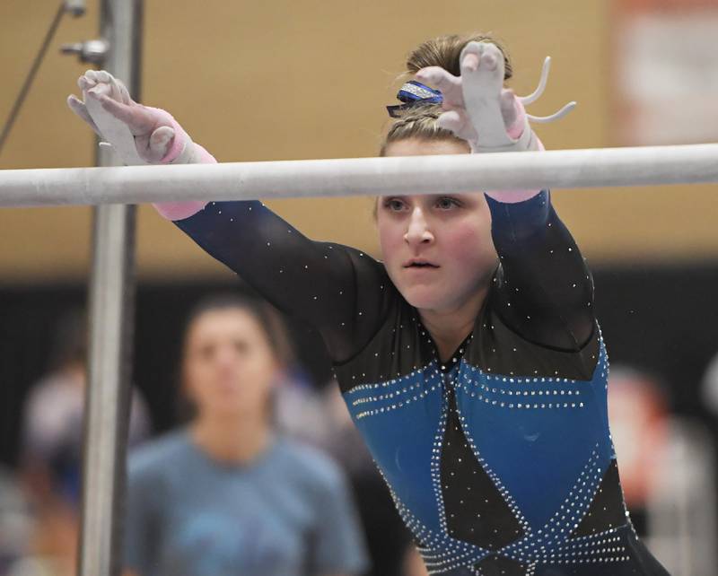 Emily Smetana of Downers Grove South High School on the uneven parallel bars at the Hinsdale South girls gymnastics sectional meet in Darien on Tuesday, February 7, 2023.