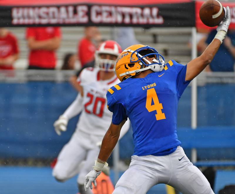 Lyons Township’s Anthony Pearson (4) gets a hand on a high pass but it fell incomplete during a game on September 20, 2025 at Lyons Township High School in LaGrange.