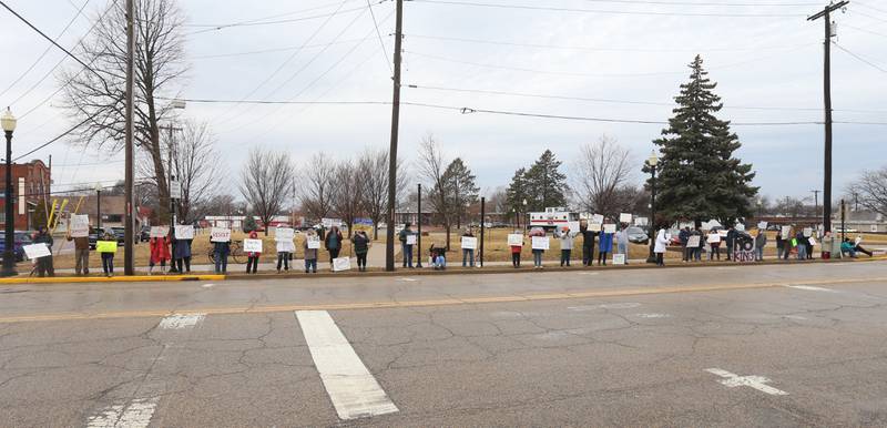 Dozens of citizens gather during a March 4 Democracy on Tuesday, March 4, 2025 at Rotary Park in Princeton. Participants brought signs to feature issues of concern for the county, state and country. The event was sponsored by concerned citizens of Bureau County.
